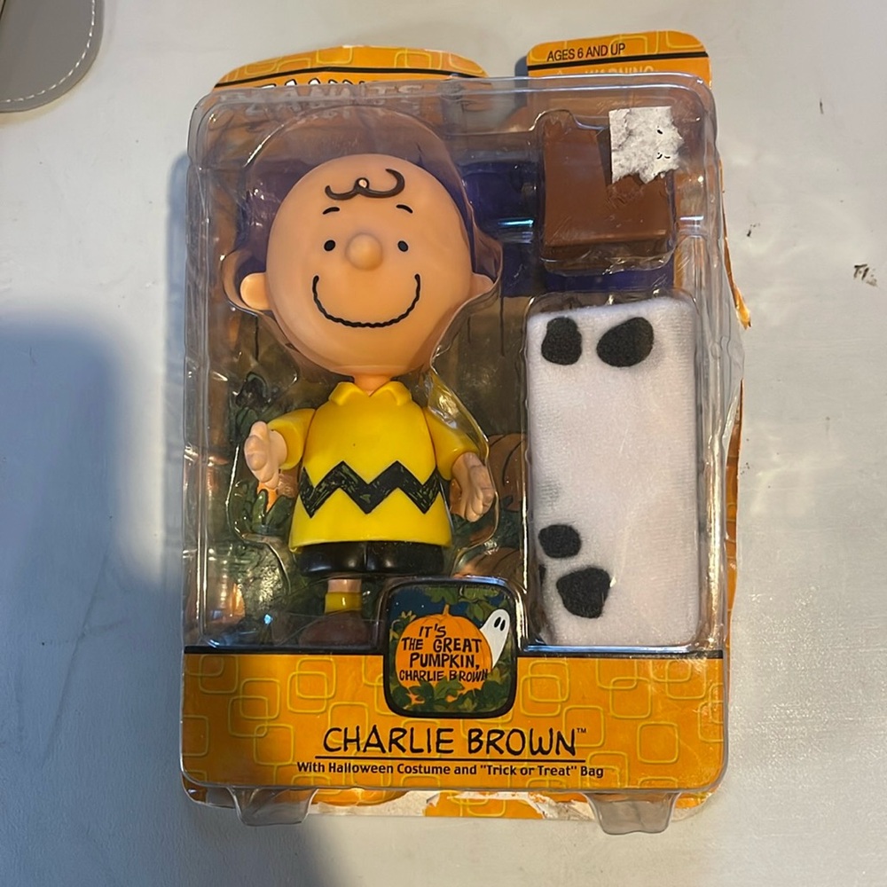 Charlie Brown with Halloween costume and trick-or-treat bag figurines